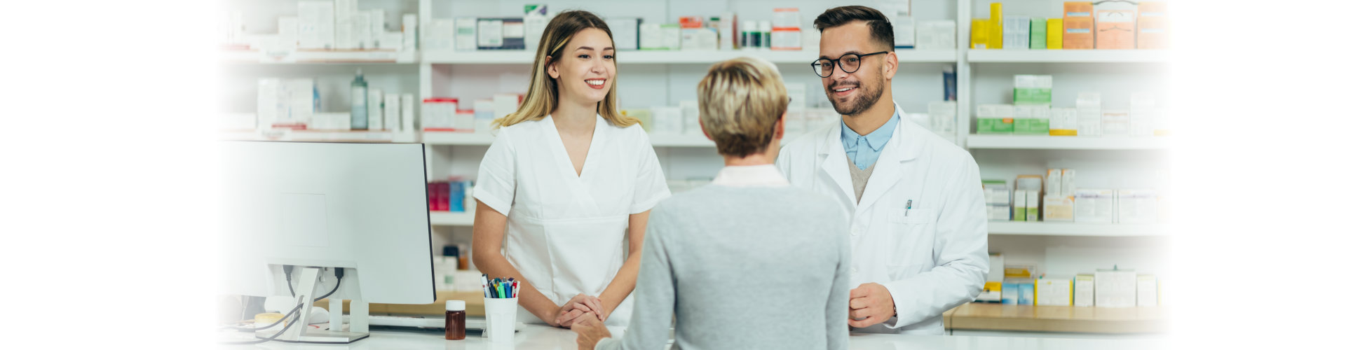 two pharmacist talking to a senior female customer